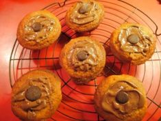 chocolate chip muffins cooling on a wire rack with peanut butter in the middle