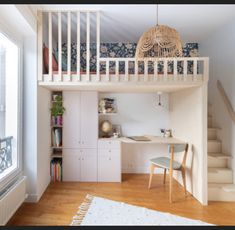 there is a loft bed and desk in this small room with stairs to the second floor