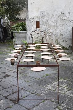 a table that has many plates on it and is sitting in front of a building