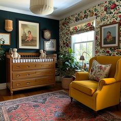 a baby's room with floral wallpaper and an old fashioned crib in the corner