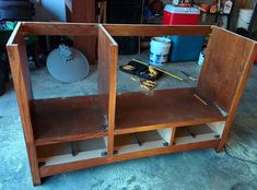 an unfinished entertainment center in the process of being built with plywood and other woodworking tools