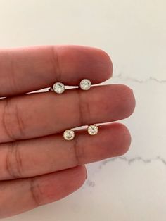 4MM Bezel Stud Earrings | CZ Earrings | Gold and Silver CZ Earrings | Bezel Stud Earrings | Gifts for Her HANDMADE-BEZEL DAINTY STUD EARRINGS   ⁙ Materials: Sterling Silver, 18K Gold over Silver, Cubic Zirconia ⁙ Available colors: Gold and Silver ⁙ Earrings Measurements: 4MM in diameter  ⁙ PROCESSING TIMES: 1-3 business days, does not include holidays or weekends ⁙  All items are packaged in plastic zip bags, please note due to hygienic reasons Earrings are final sale and cannot be exchanged or returned. Please refer to the actual dimensions as we have enlarged the pictures so that you can see the details.  OUR STORE POLICIES https://www.etsy.com/shop/ynyjewelry?ref=seller-platform-mcnav FOLLOW US Instagram: YNYJEWELRY Minimalist Earrings Silver, Dainty Gold Earrings, Earring Styles, Bezel Earrings, Dainty Studs, Small Earrings Studs, Cz Stud Earrings, Earrings Dainty, Cz Earrings