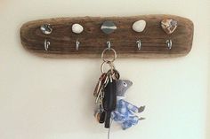 there is a key holder on the wall with keys hanging from it's hooks