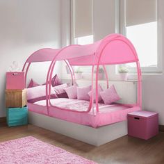 a bed with pink sheets and pillows in a room