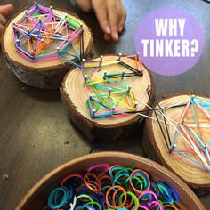 two wooden bowls filled with different colored plastic rings and sticks on top of a table