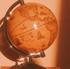 a wooden globe sitting on top of a table