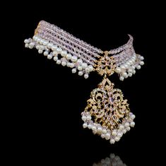 Showcase an epitome of elegance in tantalizing symphony of intricate craftsmanship and redefined traditions! A majestic set featuring a layout of beautiful CZ and pastel pink beads and stone work along with pearl embellishments. The set includes a necklace and a pair of beautiful earrings. Approximate earrings length is 3.5". Gold-plated on high-quality brass as base metal. Made by order. Kindly allow 5-7 weeks for the delivery of this item. For custom or urgent requests, please contact support@ Heritage Jewellery, Waist Chain, Stone Work, Head Accessories, Pink Beads, Men's Collection, Guinea Bissau, Base Metal, Pastel Pink