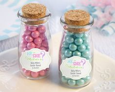 two glass jars filled with candy on top of a white plate