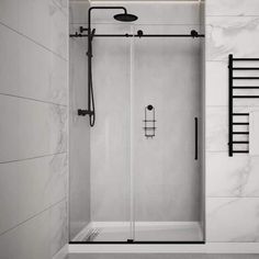 a walk in shower sitting next to a white tiled wall with black rails on it