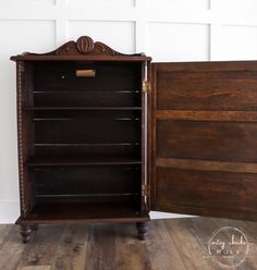 an old fashioned wooden cabinet is open on the floor