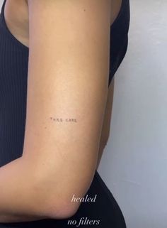 a woman's arm with the word take care written on it in cursive font