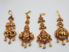 Traditional gold replica Lakshmi maang tikka studded with semiprecious stones with matte gold plating. Polish and stones are guaranteed. Very detail-oriented. Total length - 3 1/2 inches ( 9 cm ) Width - 1 1/4 inch Jewelry care instructions : 1. Keep jewelry away from direct heat, water, perfumes, deodorants and other strong chemicals. 2. Any moisture or sweat should be properly wiped off before preserving inside. Store it in air tight zip lock bags NOT in velvet box or pouch. Store it in cool, Luxury Temple Jewelry Chandbalis With Tilla, Luxury Gold Chandbalis In Temple Jewelry Style, Luxury Temple Jewelry Tikka With Meenakari, Elegant Bridal Earrings For Wedding And Navratri, Elegant Tikka With Intricate Design For Navratri, Papadi Billa Designs Gold For Bride, Elegant Ceremonial Tikka For Navratri, Gold Temple Jewelry Tikka With Stone Work, Elegant Gold Tikka For Navratri