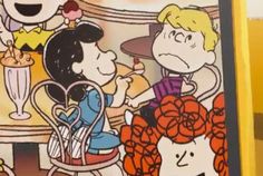 the peanuts gang is sitting at a table together