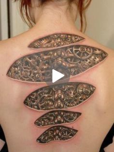 the back of a woman's neck with an intricate design on it