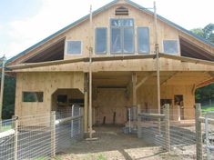 a horse barn is shown with windows on the roof