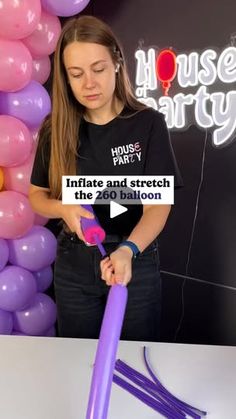 a woman holding a purple balloon in front of a sign that reads, house party