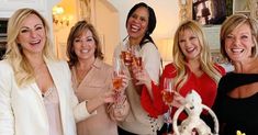 four women are holding champagne flutes in their hands