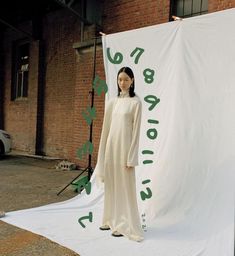 a woman standing in front of a white banner