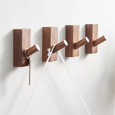 three wooden pegs are attached to the wall