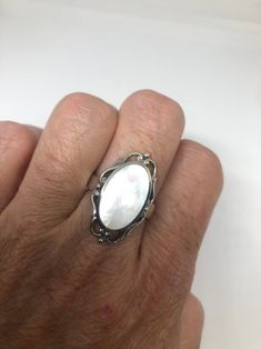 Lovely polished sterling silver has the look of Deco with a huge white Mother Of Pearl set in very detailed vintage filigree Size 7.75 We can size these with an additional $10-$20 fee for the jeweler All rings are shipped in a nice gift box. Check out our over a THOUSAND great reviews Engraving is $4 per letter and is not always perfect depending on the piece. It can take a few days if the jeweler is busy. This is payable to Paypal Judithsltd@gmail.com Classic White Filigree Ring With Intricate Design, White Heirloom Filigree Ring With Intricate Design, White Filigree Fine Jewelry, Heirloom White Filigree Ring With Intricate Design, White Filigree Ring With Intricate Design For Formal Events, White Fine Jewelry With Filigree Details, White Fine Jewelry With Filigree, Fine White Filigree Jewelry, Formal White Filigree Ring With Intricate Design