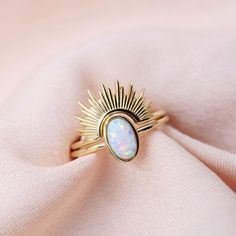 Solid gold opal ring set. Our solid gold Opal Sunburst ring set features an opal solitaire ring and a radiant sunburst ring topper. It's a dainty and delicate forever piece that you'll cherish for years to come. The sparkly opal center glistens in the light beautifully. ✨Wear the rings stacked or on their own. You can purchase the set or each ring individually. DETAILS - 10kt solid gold - Opal center stone - Available in sizes 6-9 - Sunburst ring arch can fit rings with stones up to 6mm wide - P Rings With Stones, Sunburst Ring, Gold Opal Ring, Opal Engagement Ring Set, Deer Jewelry, Opal Solitaire Ring, Stackable Ring Sets, Sterling Silver Cross Necklace, Opal Wedding Rings