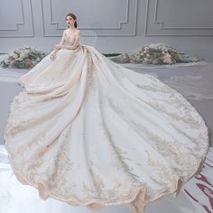 a woman in a wedding dress is standing on the floor