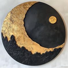 a black and gold plate with a half moon on it