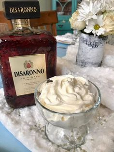 a bottle of disarrono and a bowl of whipped cream