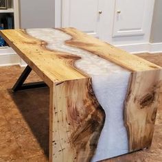 a table made out of wood with white fur on it