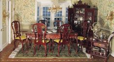 a dinning room table with chairs and china cabinet