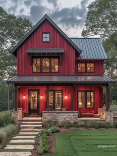 a red house with black roof and stairs leading up to the front door, surrounded by grass