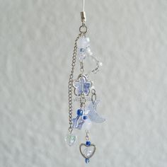 a keychain with charms hanging from it's side on a white background