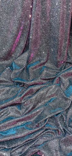 the fabric is shiny and blue with purple streaks on it's edges, as well as glitter