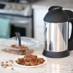 a plate of granola next to a coffee pot