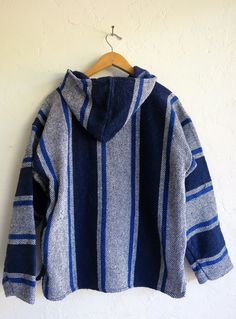 Make this poncho yours. Estimate Size: Women's Medium 100% Acrylic Length: 23.5 in. Bust: 44 in. Waist: 43 in. Shoulder: 16.5 in. Blue Cozy Poncho One Size, Bohemian Blue Hooded Outerwear, Blue Bohemian Hooded Outerwear, Casual Blue Cotton Poncho, Blue Hooded Winter Cape, Casual Cotton Poncho For Winter, Cozy Oversized Cape With Long Sleeves, Cozy Long Sleeve Cape For Cold Weather, Casual Hooded Winter Cape