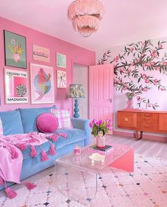 a pink and blue living room with pictures on the wall