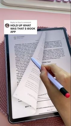 a person is holding a pen and pointing at an e - book on a tablet