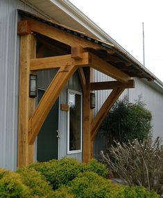 an image of a building that is made out of wood and has a metal roof