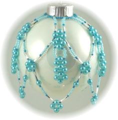 a white ornament with blue beads on it