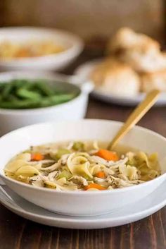 a bowl of chicken noodle soup on a table