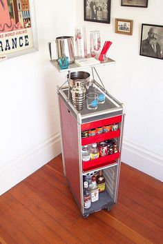 the small cart is stocked with drinks and condiments on it's wheels