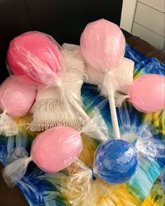 some lollipops are wrapped in plastic and sitting on top of a table