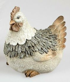 a white and brown chicken figurine sitting on top of a table