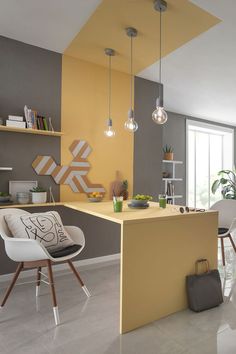 a modern kitchen with yellow and gray walls