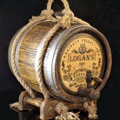 a wooden barrel with rope hanging from it's side on a black table top