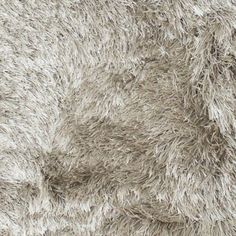 a close up view of the texture of a shaggy rug with no fur on it