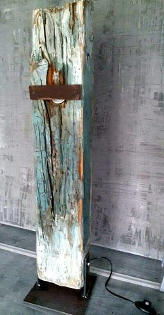 an old wooden object is on display in a room with gray walls and flooring