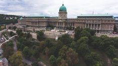 an aerial view of a large building with a green dome on it's roof