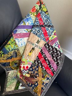 a patchwork blanket sitting on top of a black chair