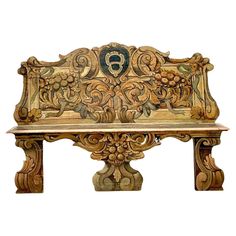 an ornate wooden bench with carvings on the back and sides, sitting in front of a white background